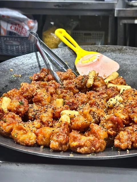 Visitors tasting fifteen local dishes at buzzing Mangwon Market on a seoul food tours neighbourhood crawl in Seoul, South Korea